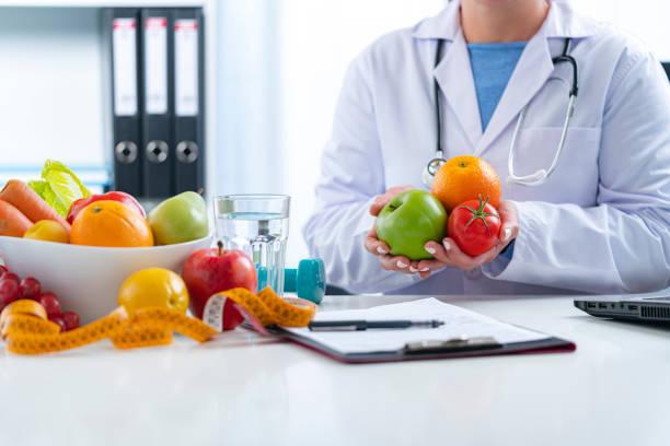 istock Nutritionist holding some fruits and vegetables 1317299765