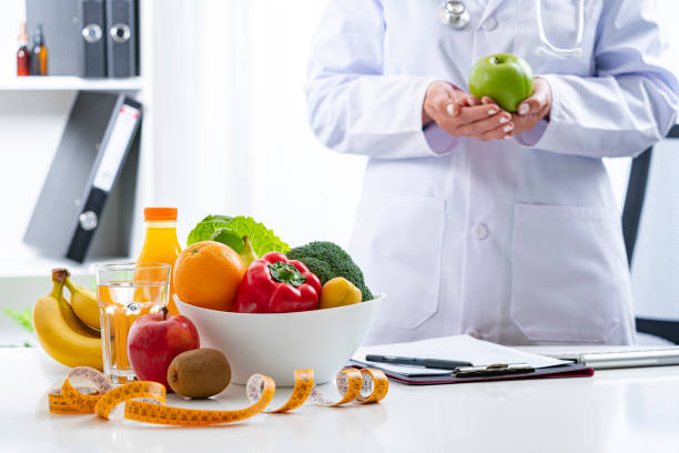 istock Nutritionist showing a green apple 1317299767