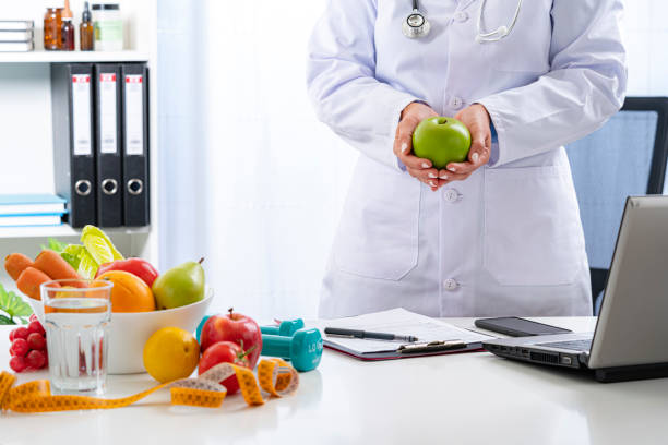 istock Nutritionist holding a green apple 1317299768