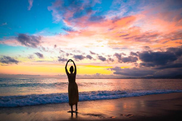 istock Young woman on the beach at sunset 1317303305