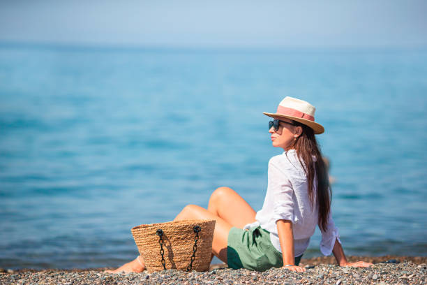 istock Young woman in hat on the beach vacation 1317303382