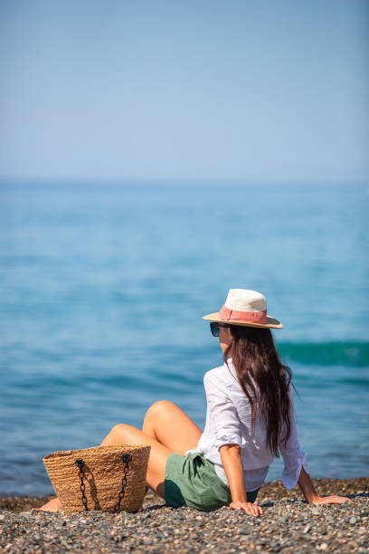 istock Young woman in hat on the beach vacation 1317303404