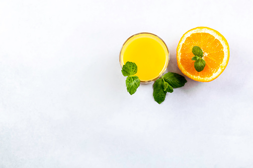 Fresh orange juice on a white background. Proper nutrition. Vitamin drink. Detox.