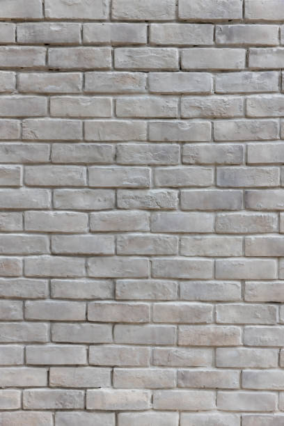 istock White brick wall background in rural room. Abstract weathered texture stained old stucco light gray. White grunge brick wall background. Misty brick wall for background or texture. 1317306163
