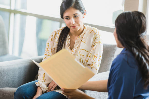 istock Female employee listens to unrecognizable manager during performance review 1317309291