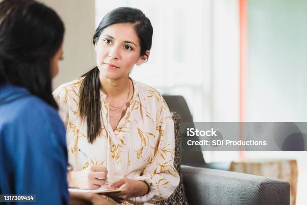 Caring Counselor Listening To Female Patient Stock Photo - Download Image Now - Mental Health Professional, Empathy, Psychotherapy