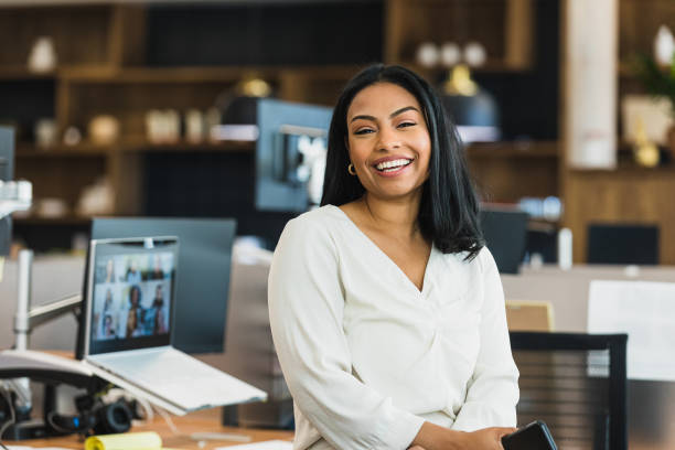 Female business owner poses for photo at work