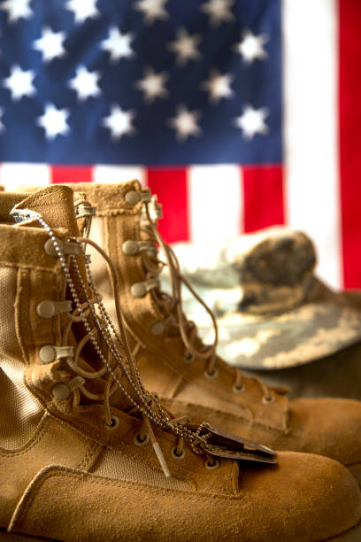 istock US Military Display.  Modern day military boots and cap. 1317310376