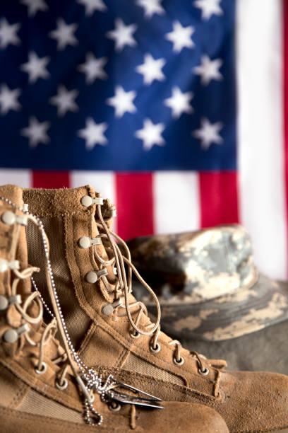 istock US Military Display.  Modern day military boots and cap. 1317310672