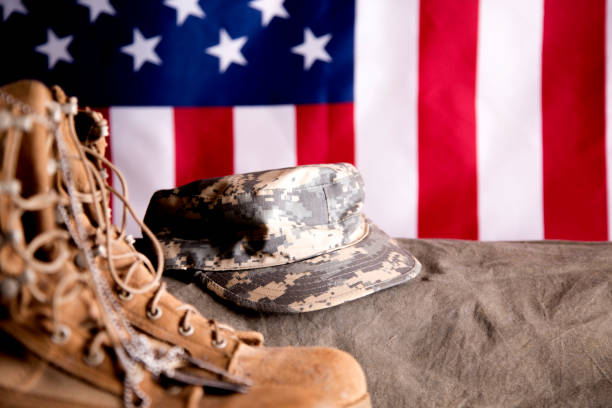istock US Military Display.  Modern day military boots and cap. 1317310673