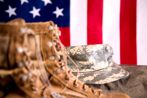 istock US Military Display.  Modern day military boots and cap. 1317310788