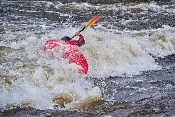 istock kayaker surfing wave in Poudre River Whitewater Park 1317310848