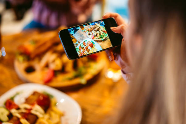istock Photographing food in restaurant before eating 1317311196