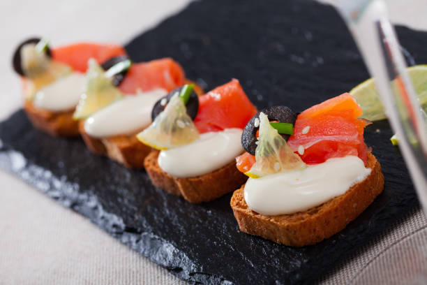 istock Tasty canape with salmon and olives 1317311966