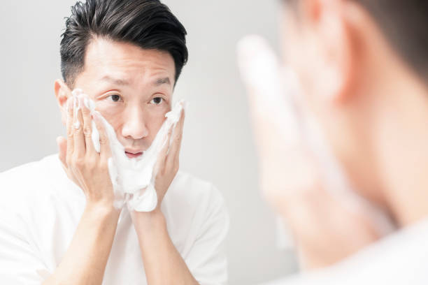 istock Middle-aged man washing his face 1317312595