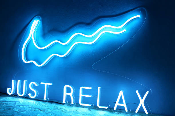 Blue neon sign just relax. Trendy style.