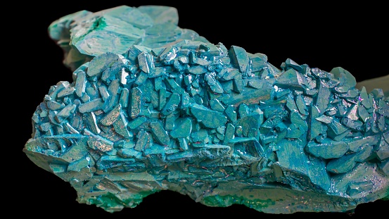 copper ammonium carbonate. blue crystals on a black background. macro.