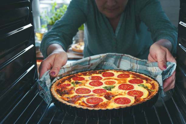 istock Preparing Quiche Lorraine with Tomatoes and Bacon 1317317946