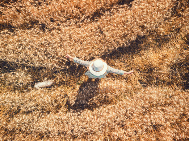 istock Beautiful woman walking through wheat field 1317319437