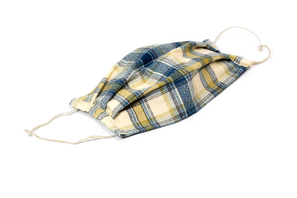 istock Home Made Face Mask of plaid fabric on a white background 1317320453