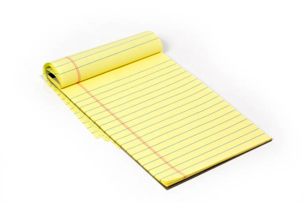 istock Note Pad with ruled yellow paper on a white background. 1317320463