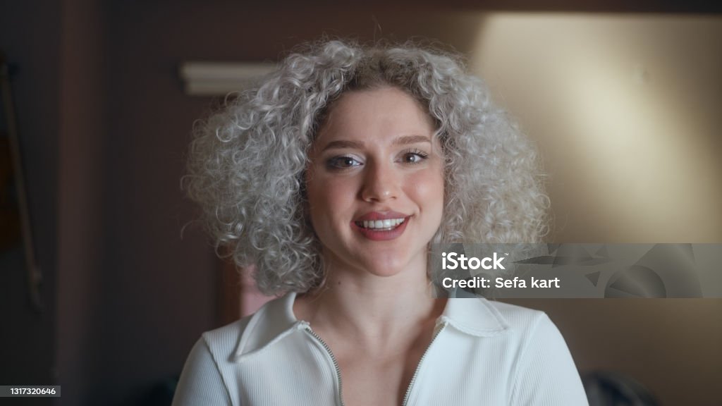 Portrait of happy beautiful woman with curly white-hair. White Hair Stock Photo