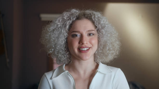 portrait of happy beautiful woman with curly white-hair. - white hair imagens e fotografias de stock