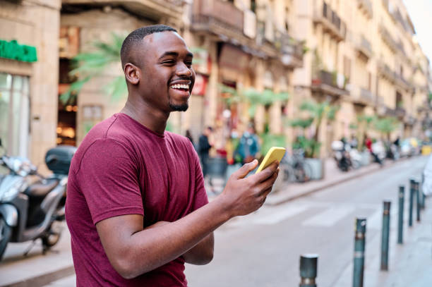 istock young man using smartphone aoutdoors in the middle of the street 1317321390