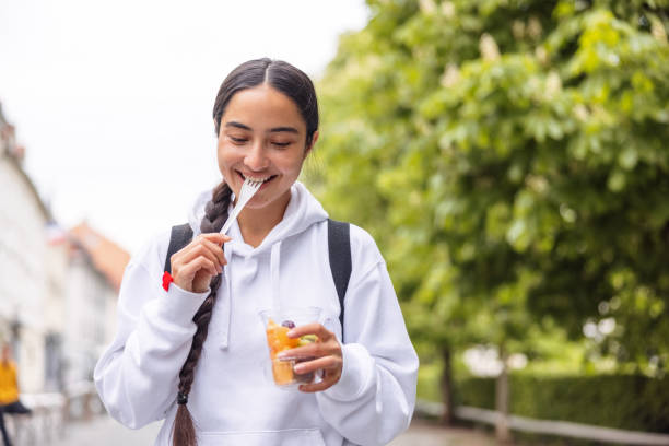 istock Beautiful Woman Eating A Fruit Salad 1317322526
