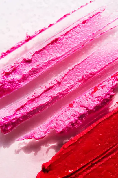 Photo of Lipstick or lip gloss swatch macro wallpaper. Beauty horizontal smears texture. Liquid makeup closeup.