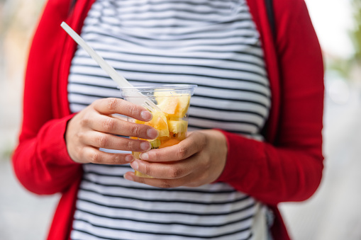 Close Up Of A Woman Holding A Fruit Salad