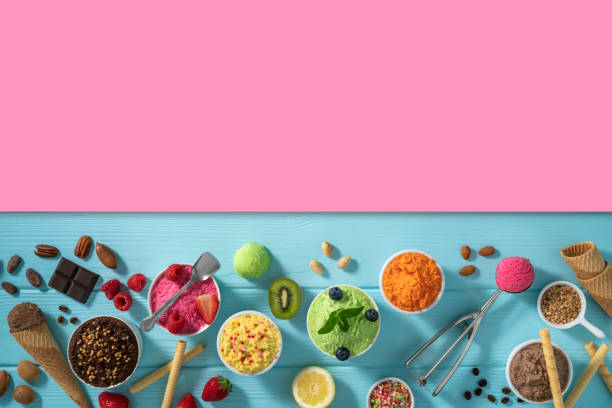 istock Assorted ice cream cups and waffle cones colorful different flavor on blue wood 1317328096