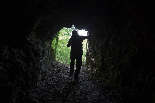 istock Adventurer at rock cave 1317329013