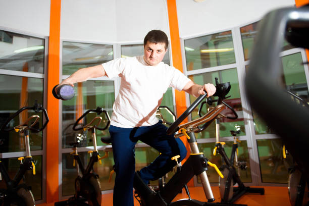 istock Athletic young man having stationary bike workout 1317333048