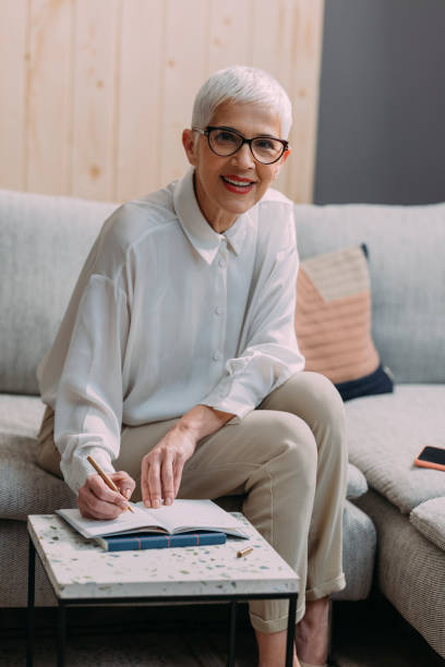 istock Beautiful Senior Businesswoman Making a Schedule in her Notebook 1317338027
