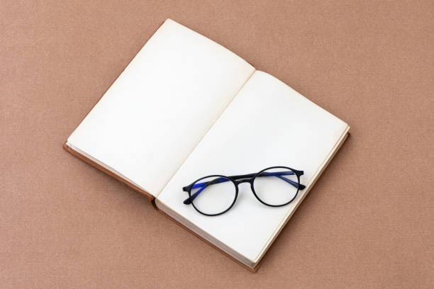 istock Old books with eye-glasses isolated on craft background. 1317339064