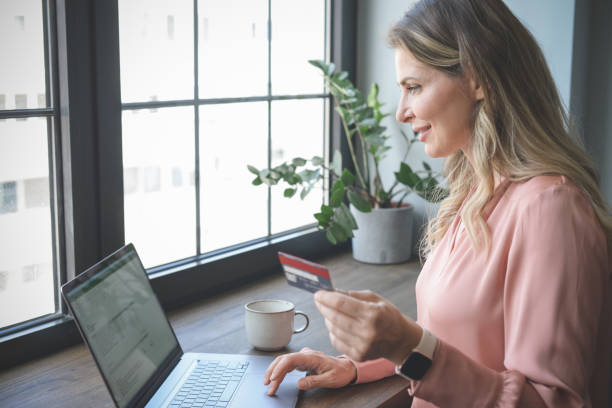 istock attractive middle aged woman working in the office ( Online Shopping) 1317341530