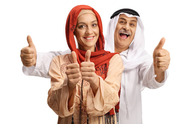 jovem muçulmana e um homem árabe maduro gesticulando polegares para cima - headscarf islam senior adult east - fotografias e filmes do acervo