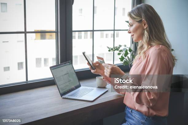 Attractive Middle Aged Woman Working In The Office Stock Photo - Download Image Now