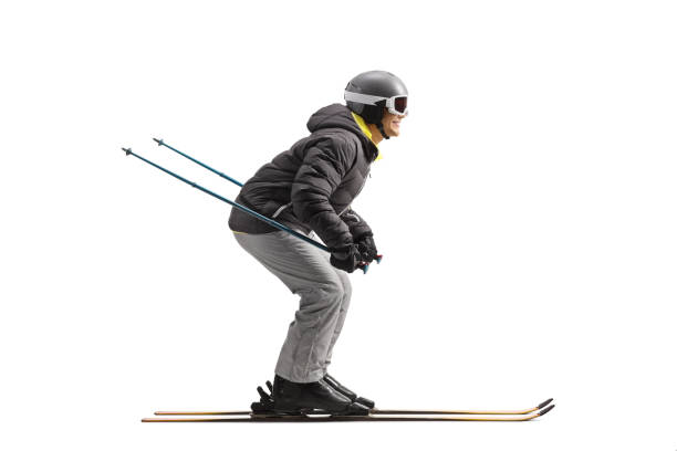Full length profile shot of a man skiing isolated on a white background