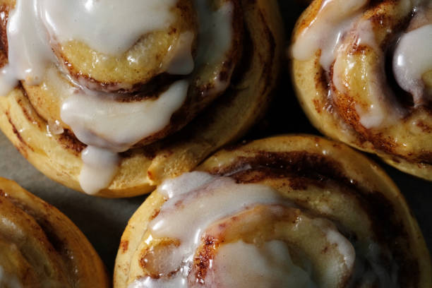 Top view close up of cinnamon rolls with icing drip
