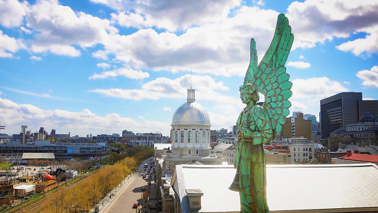 Montreal elevated view of the old town with a 19th century angel statue in the foreground