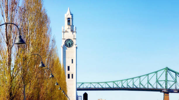 istock Old Montreal white clock tower with Jacques-Cartier bridge on a sunny Springtime day 1317355180