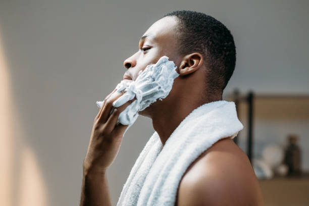 istock male grooming african man applying shaving foam 1317362765