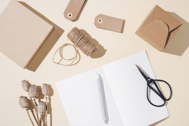 istock Top view of open notebook with blank pages and packaging gift on table, autumn concept. Creative workspace 1317365523