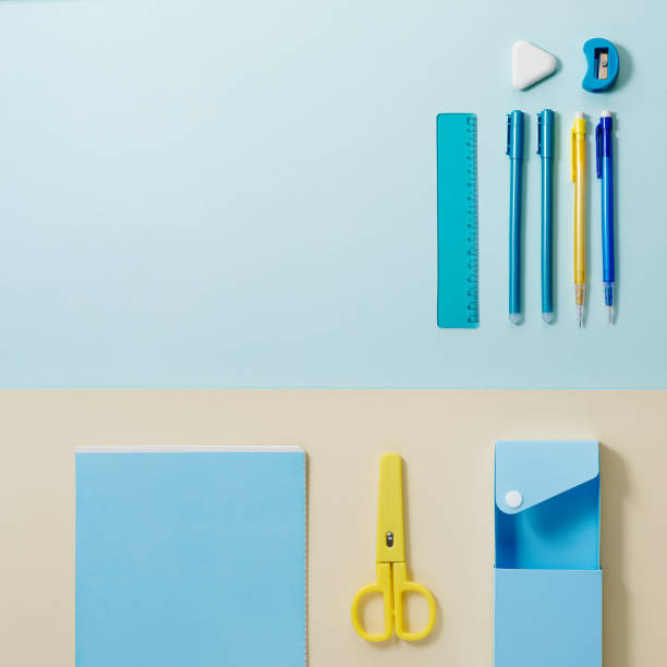 istock School stationery in yellow and blue tone. Office accessories study and educational flat lay. 1317365555