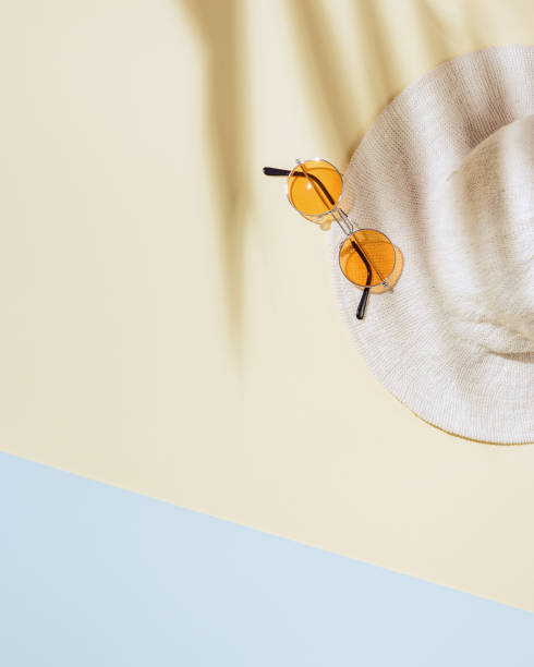 istock Summer minimal background with sun hat, colored sunglasses with palm shadows. Summertime concept pastel colored aesthetic photo. 1317365567