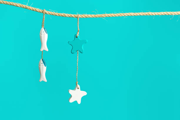 istock Summer composition with marine items hanging. Sea toys seastars and small fish 1317365579