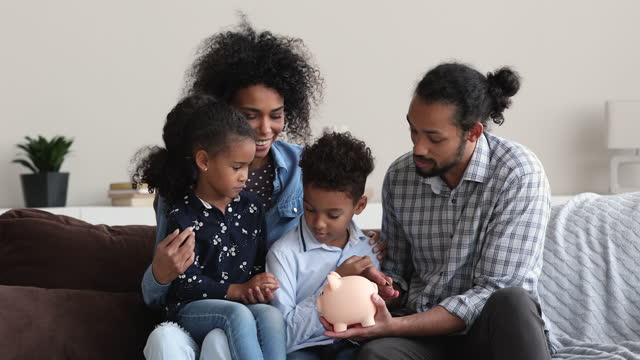 African ethnicity couple teach little children to save money