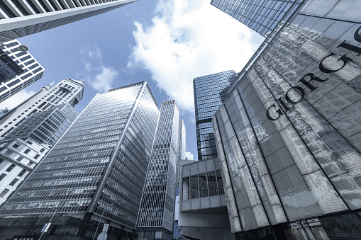 Hong Kong - May 8, 2021: City view in Chater Road in Central district. Central area is main commercial district of Hong Kong. The surrounding buildings are Wheelock House, World Wide House, JP Morgan Chase Bank, Alexandra House